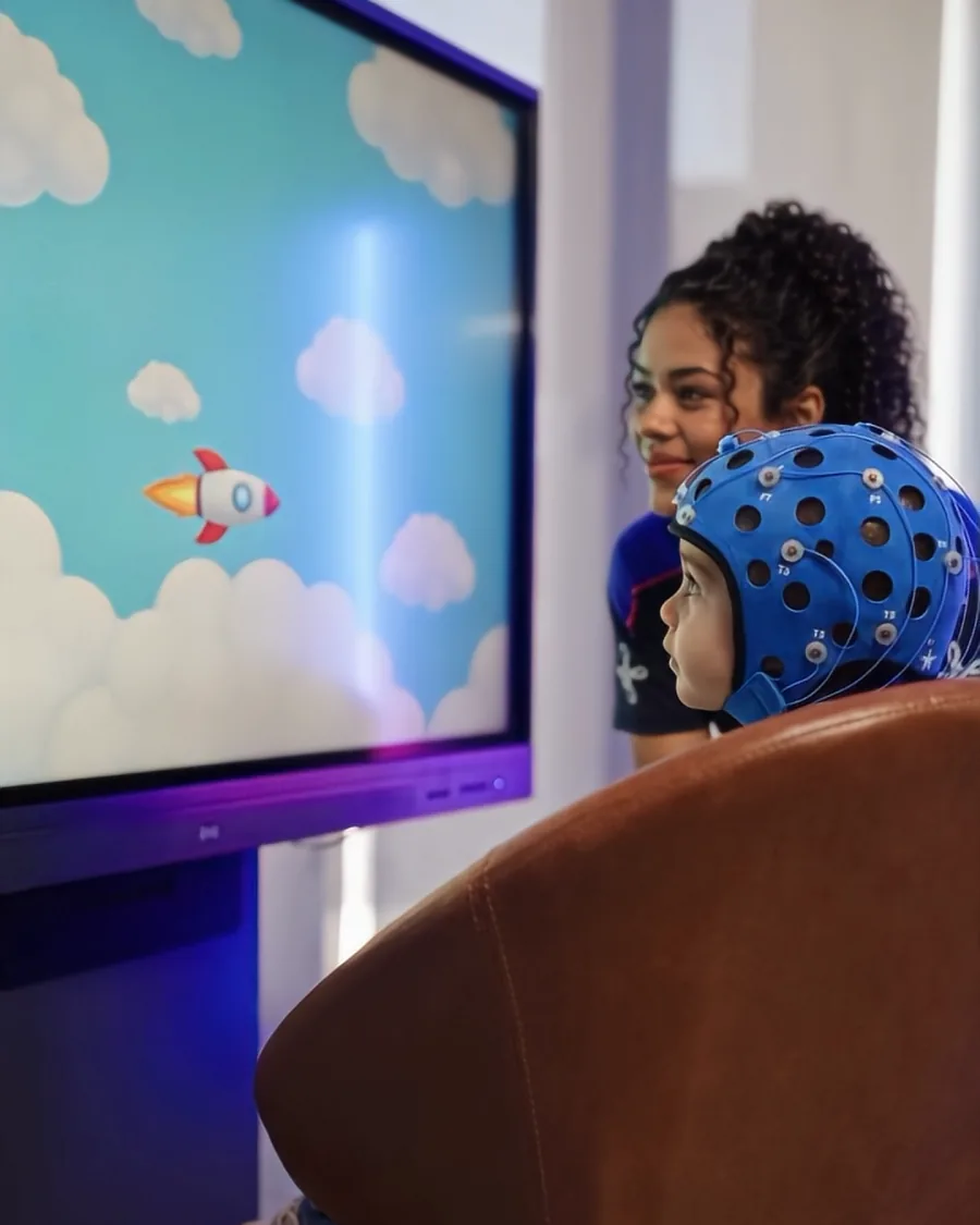 Criança de touca jogando um jogo na tela